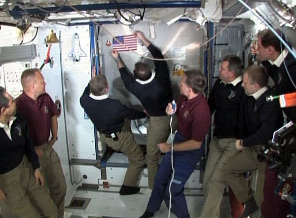 Astronauts Leave American Flag, Shuttle Model on Space Station in Tribute